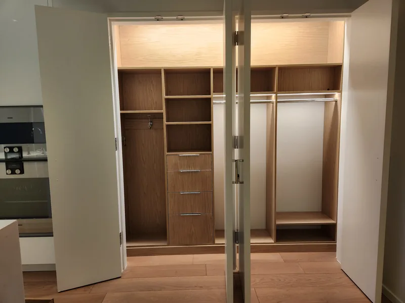 Wood-finish reach-in wardrobe with upper storage, drawers and two hanging sections